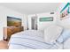 Spacious bedroom with a large window, wood dresser, and a comfortable queen bed at 1 Key Capri # 303E, Treasure Island, FL 33706