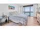 Bedroom featuring large window views, a queen bed, and minimalist decor at 1 Key Capri # 303E, Treasure Island, FL 33706