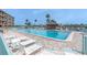 A large pool is surrounded by lounge chairs for residents to relax and soak up the sun at 1 Key Capri # 303E, Treasure Island, FL 33706
