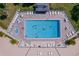 Aerial view of a large pool with lounge chairs and tables for residents to relax by the water at 1 Key Capri # 303E, Treasure Island, FL 33706