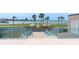 Stairway down to a park with a playground and bocce ball court with a view of the harbor at 1 Key Capri # 303E, Treasure Island, FL 33706