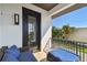 Charming balcony with blue outdoor seating, black metal railing and a view of palm trees at 101 Biscayne Ave, Tampa, FL 33606