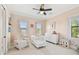 Bright bedroom features neutral paint, ceiling fan, multiple windows, and white wooden baby furniture at 101 Biscayne Ave, Tampa, FL 33606