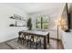 Bright dining area with a large window, modern decor, and a dark wood table at 101 Biscayne Ave, Tampa, FL 33606