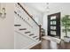 Elegant foyer featuring a modern light fixture, dark hardwood floors, and a black-framed glass door at 101 Biscayne Ave, Tampa, FL 33606