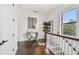Bright hallway boasts hardwood floors, white trim, a stylish console table, and a window at 101 Biscayne Ave, Tampa, FL 33606