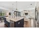 Open-concept kitchen with a large island, stainless steel appliances, and a view of the living room at 101 Biscayne Ave, Tampa, FL 33606