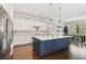Bright, open kitchen with a large center island, white cabinets, stainless steel appliances, and an adjacent dining area at 101 Biscayne Ave, Tampa, FL 33606