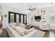 Bright living room with custom built-in shelving, a cozy sectional, and large glass doors to the balcony at 101 Biscayne Ave, Tampa, FL 33606