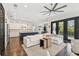 Open-concept living room with a modern kitchen, white sectional sofa, and access to a balcony at 101 Biscayne Ave, Tampa, FL 33606