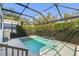 Backyard pool features privacy screen, in ground hot tub, and stairs into the pool at 101 Biscayne Ave, Tampa, FL 33606