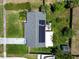 Birds eye view of home with solar panels, shed, boat, and fenced yard at 1011 Coldstream Ct, Tarpon Springs, FL 34689