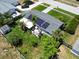 Aerial view showcasing solar panels, screened patio, outdoor patio and fully fenced backyard at 1011 Coldstream Ct, Tarpon Springs, FL 34689
