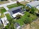 Aerial view of a beautiful fenced yard with an outdoor patio and solar panels installed at 1011 Coldstream Ct, Tarpon Springs, FL 34689
