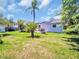 Backyard featuring lawn, palm trees and a patio with outdoor seating at 1011 Coldstream Ct, Tarpon Springs, FL 34689