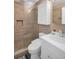 Bathroom featuring a tiled walk-in shower, a modern sink, and updated plumbing fixtures at 1011 Coldstream Ct, Tarpon Springs, FL 34689