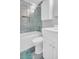 Bathroom featuring a glass-enclosed tub and shower, along with white vanity and fixtures at 1011 Coldstream Ct, Tarpon Springs, FL 34689