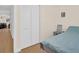 Simple bedroom view showcasing wood-look floors and a closet with louvered doors at 1011 Coldstream Ct, Tarpon Springs, FL 34689