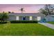 Charming single-story home with a well-manicured front yard and a bright blue door at 1011 Coldstream Ct, Tarpon Springs, FL 34689
