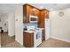 Functional kitchen with wood cabinets, white appliances, and a light blue backsplash at 1011 Coldstream Ct, Tarpon Springs, FL 34689
