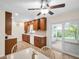 A well-appointed kitchen featuring warm wood cabinets and a view to the sunny outdoor patio at 1011 Coldstream Ct, Tarpon Springs, FL 34689