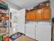 Laundry area with a washer, dryer, and upper cabinets for easy storage solutions at 1011 Coldstream Ct, Tarpon Springs, FL 34689