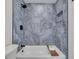 Luxurious bathroom showcasing a tub with stone tile surround and a sleek rain shower at 104 Meadowcross Dr, Safety Harbor, FL 34695