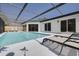 Relaxing screened-in pool area with lounge chairs and ample space for outdoor entertaining at 104 Meadowcross Dr, Safety Harbor, FL 34695