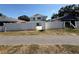 View of the backyard area with a white fence and a two-story home in the background at 10414 Rosemount Dr, Tampa, FL 33624