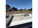Backyard area with a white fence, shed, and grass at 10414 Rosemount Dr, Tampa, FL 33624