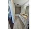 This bathroom features granite countertops, white cabinets, a tiled shower, and neutral tile flooring at 10414 Rosemount Dr, Tampa, FL 33624