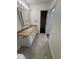 A well-lit bathroom features granite countertops, white cabinets, a tiled shower, and neutral tile flooring at 10414 Rosemount Dr, Tampa, FL 33624