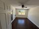 Bright bedroom with a ceiling fan, dark wood floors, and a window at 10414 Rosemount Dr, Tampa, FL 33624