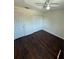 Well-lit bedroom features a ceiling fan, closet, door, and wood-look flooring at 10414 Rosemount Dr, Tampa, FL 33624