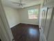 Well-lit bedroom features a ceiling fan, dark wood floor, and a bright window view at 10414 Rosemount Dr, Tampa, FL 33624