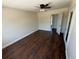 An airy bedroom with a ceiling fan and sleek, dark laminate flooring throughout at 10414 Rosemount Dr, Tampa, FL 33624