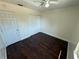This cozy bedroom is complete with ceiling fan, bi-fold closet, and wood-look flooring at 10414 Rosemount Dr, Tampa, FL 33624