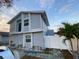 Two-story townhouse boasts a freshly painted exterior, a white fence, and a well-manicured lawn at 10414 Rosemount Dr, Tampa, FL 33624
