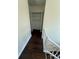 Hallway with view of closet and staircase featuring wood-look floors at 10414 Rosemount Dr, Tampa, FL 33624