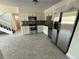 Kitchen with stainless steel appliances, white cabinets and staircase at 10414 Rosemount Dr, Tampa, FL 33624
