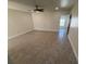 Spacious living room is complete with a modern ceiling fan and updated flooring at 10414 Rosemount Dr, Tampa, FL 33624