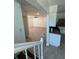 Open-concept layout with tile flooring, leading to a living room with a ceiling fan and a view of the kitchen at 10414 Rosemount Dr, Tampa, FL 33624