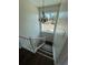 Bright view of a staircase, accented by a decorative light fixture and a large window overlooking the front yard at 10414 Rosemount Dr, Tampa, FL 33624