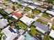 An aerial view of the home showcasing the backyard patio set, neighboring properties, and landscaping at 11225 59Th Ave, Seminole, FL 33772