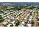 Aerial view of a residential neighborhood featuring tree-lined streets and a community pond with a fountain at 11225 59Th Ave, Seminole, FL 33772
