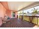 Covered back porch with wooden railings, chairs, providing a relaxing outdoor space at 11225 59Th Ave, Seminole, FL 33772