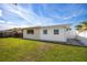 Exterior of the home with a grassy backyard and a covered porch for relaxation and entertainment at 11225 59Th Ave, Seminole, FL 33772