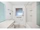 Well-lit bathroom with tile shower, safety grab bars, and modern commode at 11225 59Th Ave, Seminole, FL 33772