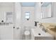 Cozy bathroom with a toilet, sink, mirror, small window, and washer/dryer connections at 11225 59Th Ave, Seminole, FL 33772