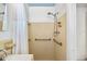 Tiled bathroom featuring a shower with grab bars, accessible shower head, and updated fixtures at 11225 59Th Ave, Seminole, FL 33772